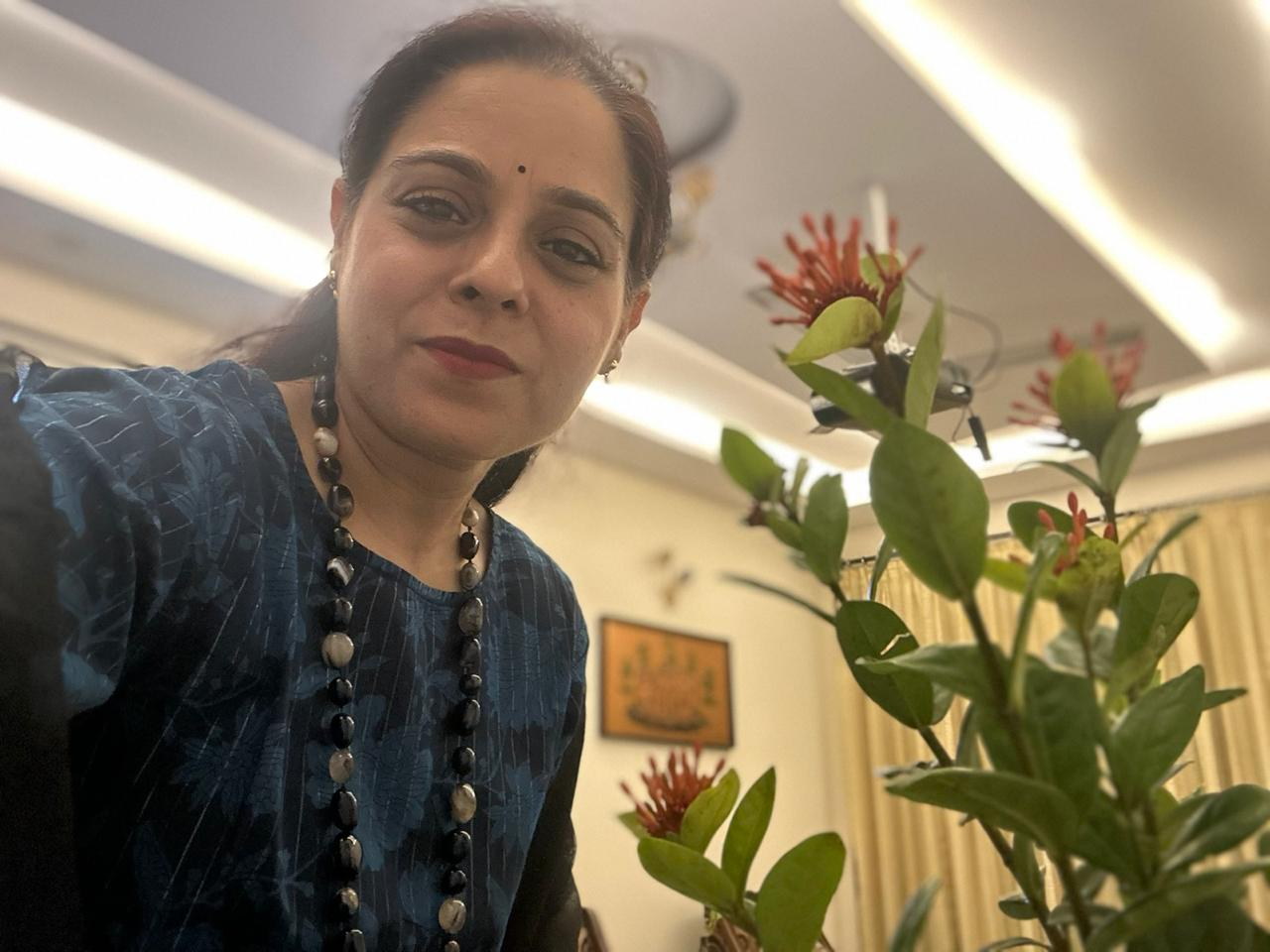 Pavit Saxena beside a flowering plant, wearing a blue patterned kurta.