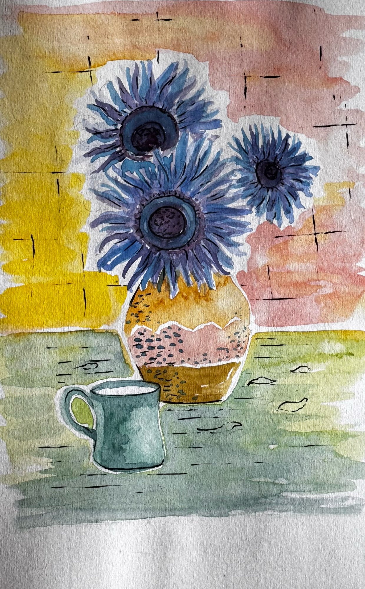 Blue flowers in a patterned vase beside a small blue cup.