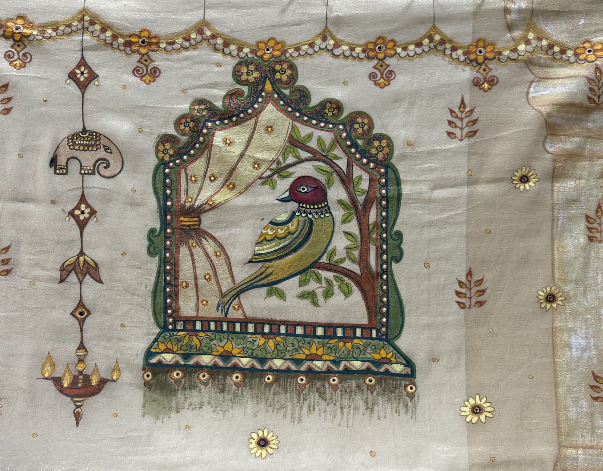 Decorative bird framed by curtains and ornamental motifs on cream silk.